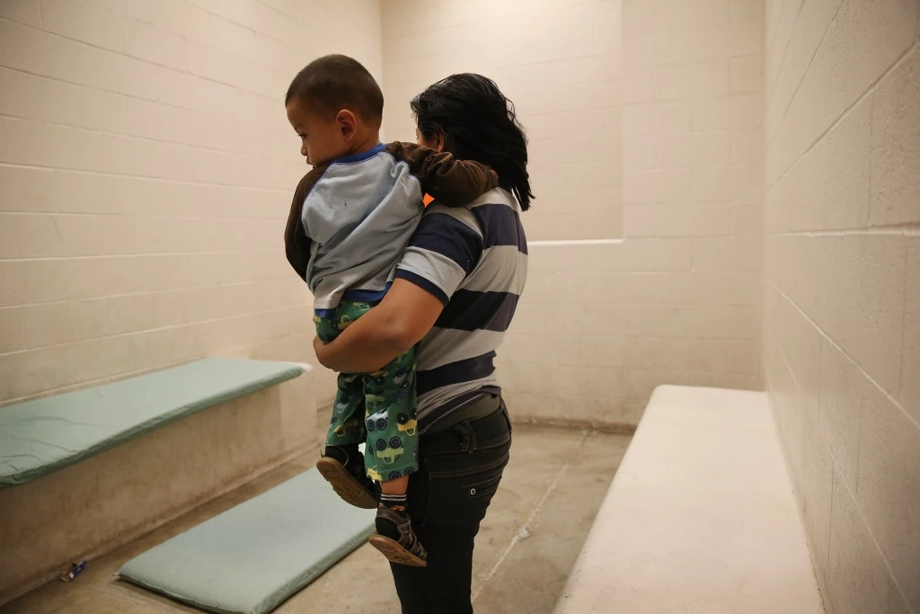 MCALLEN, TX - APRIL 11: A Honduran mother holds her toddler son at the U.S. Border Patrol detainee processing center on April 11, 2013 in McAllen, Texas. They had been caught by the Border Patrol while crossing illegally from Mexico into Texas. According to the Border Patrol, undocumented immigrant crossings have increased more than 50 percent in Texas' Rio Grande Valley sector in the last year. With more apprehensions, they have struggled to deal with overcrowding while undocumented immigrants are processed for deportation. (Photo by John Moore/Getty Images)