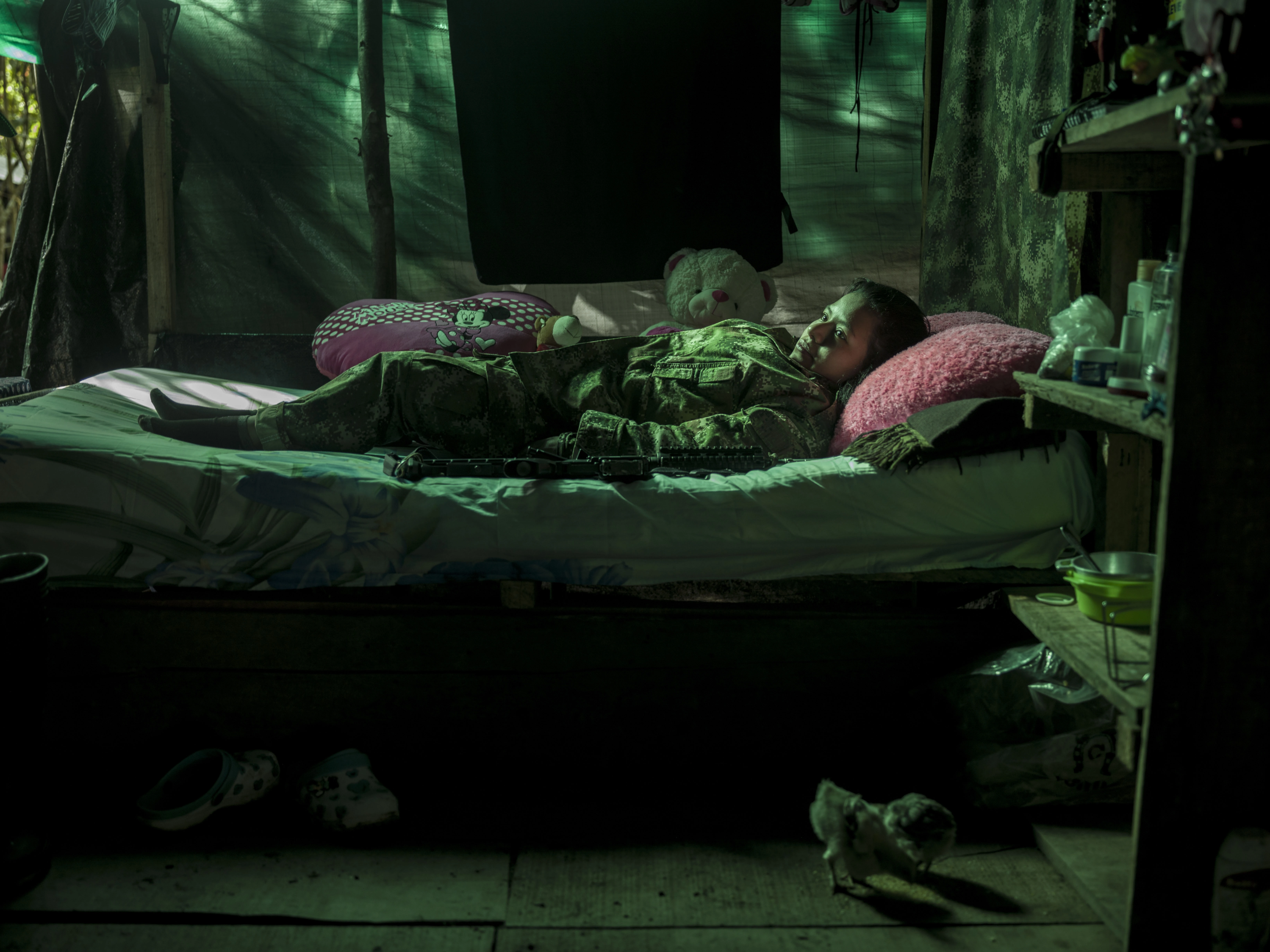 COLOMBIA. 2017. Andrea Cepeda, 23, joined the guerrilla 8 years ago when she was 16. "My father was also a Farc guerrilla, when I was 11 he was killed, after that my mother took all her children to Cali and we started working on a land as farmers. While we were working the Farc guerrillas where there most of the time and I was wondering all the time that I should join them along with my sister. So one day I made my decision and left the house. Since I was a small girl, when we would go to battle my commander did not want me not to be in the front line and my task was to take care of the other commanders in the back. All my belongings from these past 8 years can be packed into just one small backpack because we had to run away all the time and we didn't have time to pack and we always had to be ready. I lost my best friend in an attack, I wish she was here with me. I'm scared of my future, because of the paramilitary who want to kill us."