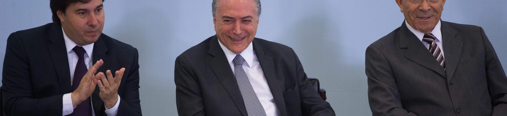 Brazilian President Michel Temer (C), Lower House President Rodrigo Maia and Chief of Staff Eliseu Padilha (R) attend a ceremony to promote new economy laws at Plantalto palace on October 27, 2016.Temer, who took over after the impeachment of Dilma Rousseff in August, urged an oil and gas conference in Rio de Janeiro to join what he said was an economy on the mend. / AFP / ANDRESSA ANHOLETE (Photo credit should read ANDRESSA ANHOLETE/AFP/Getty Images) Brazilian President Michel Temer (C), Lower House President Rodrigo Maia and Chief of Staff Eliseu Padilha (R) attend a ceremony to promote new economy laws at Plantalto palace on October 27, 2016.Temer, who took over after the impeachment of Dilma Rousseff in August, urged an oil and gas conference in Rio de Janeiro to join what he said was an economy on the mend. / AFP / ANDRESSA ANHOLETE (Photo credit should read ANDRESSA ANHOLETE/AFP/Getty Images)